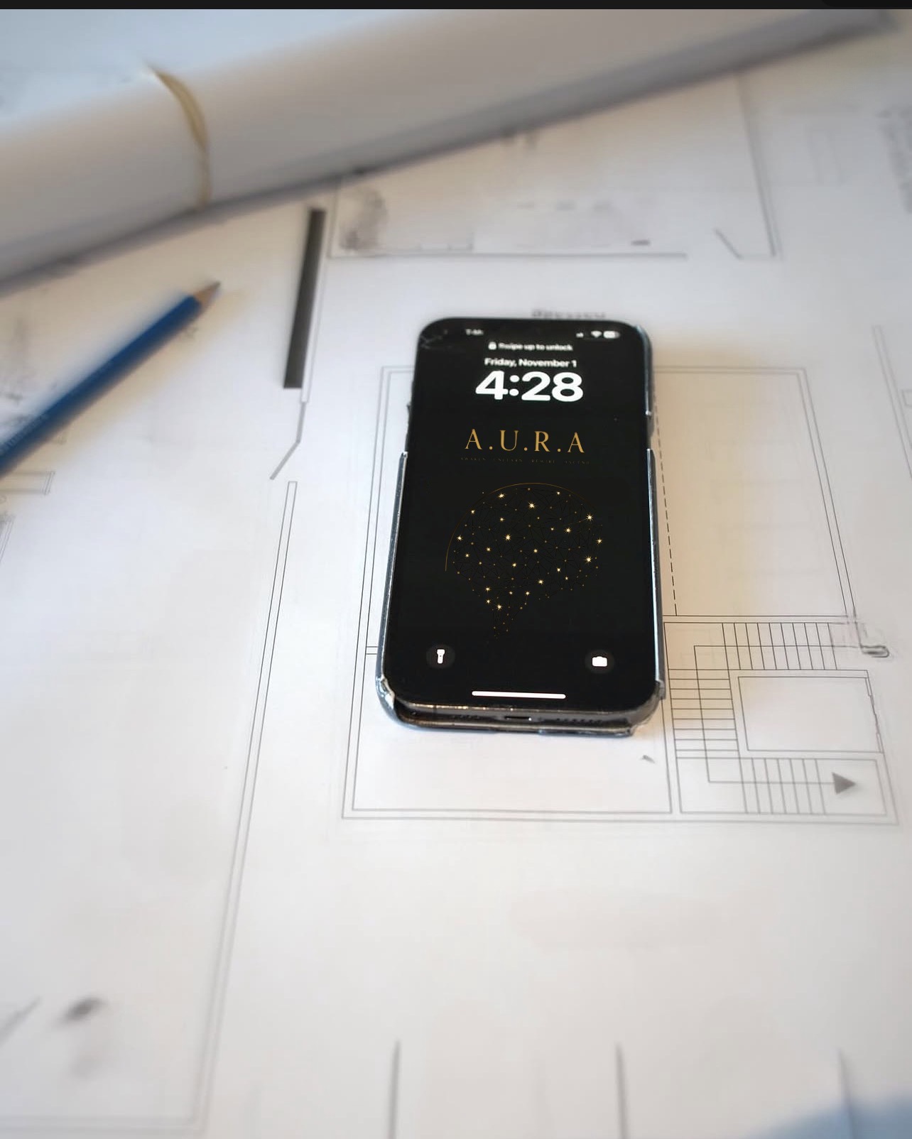 AURA phone resting on architectural plans